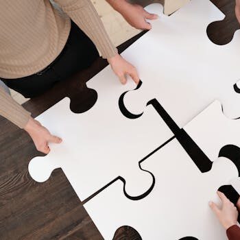 Group collaborating on assembling large puzzle pieces symbolizing teamwork and unity.