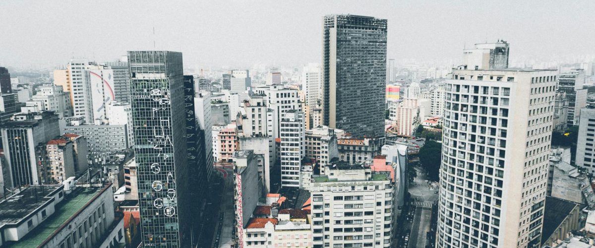 Vibrant urban cityscape showcasing diverse modern architecture under a clear sky.